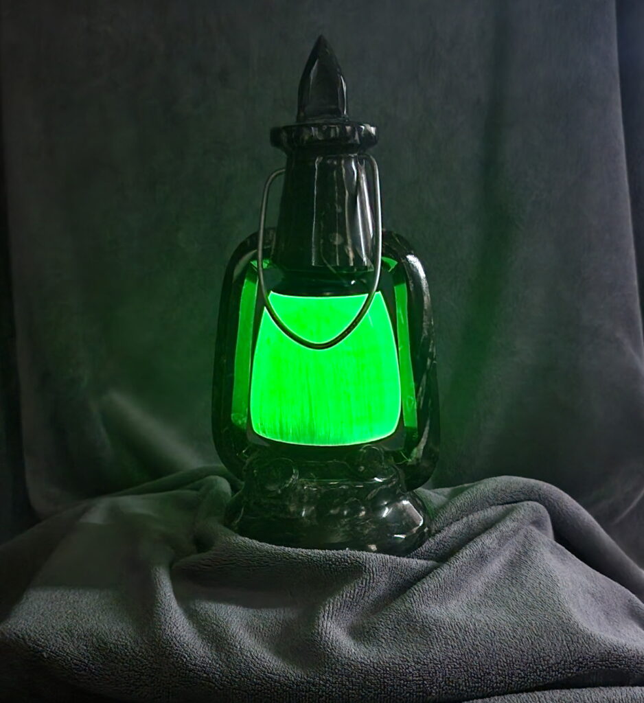 The Natural Spirit Connection Crystal Lantern in green, with a gray background.