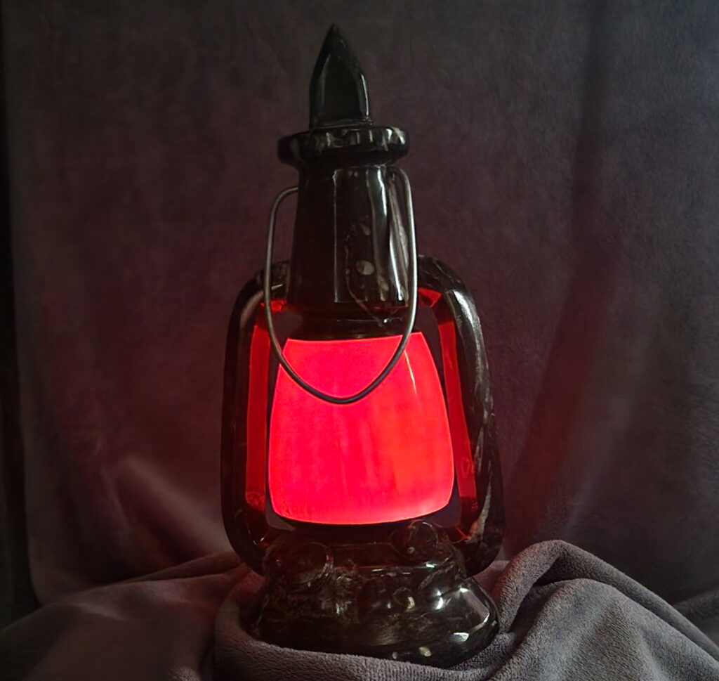 The Natural Spirit Connection crystal lantern in red, with a gray background.